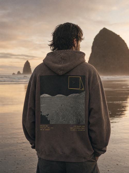 Apollo 17 Hoodie - model on Cannon Beach at sunset, lunar back print, cinematic