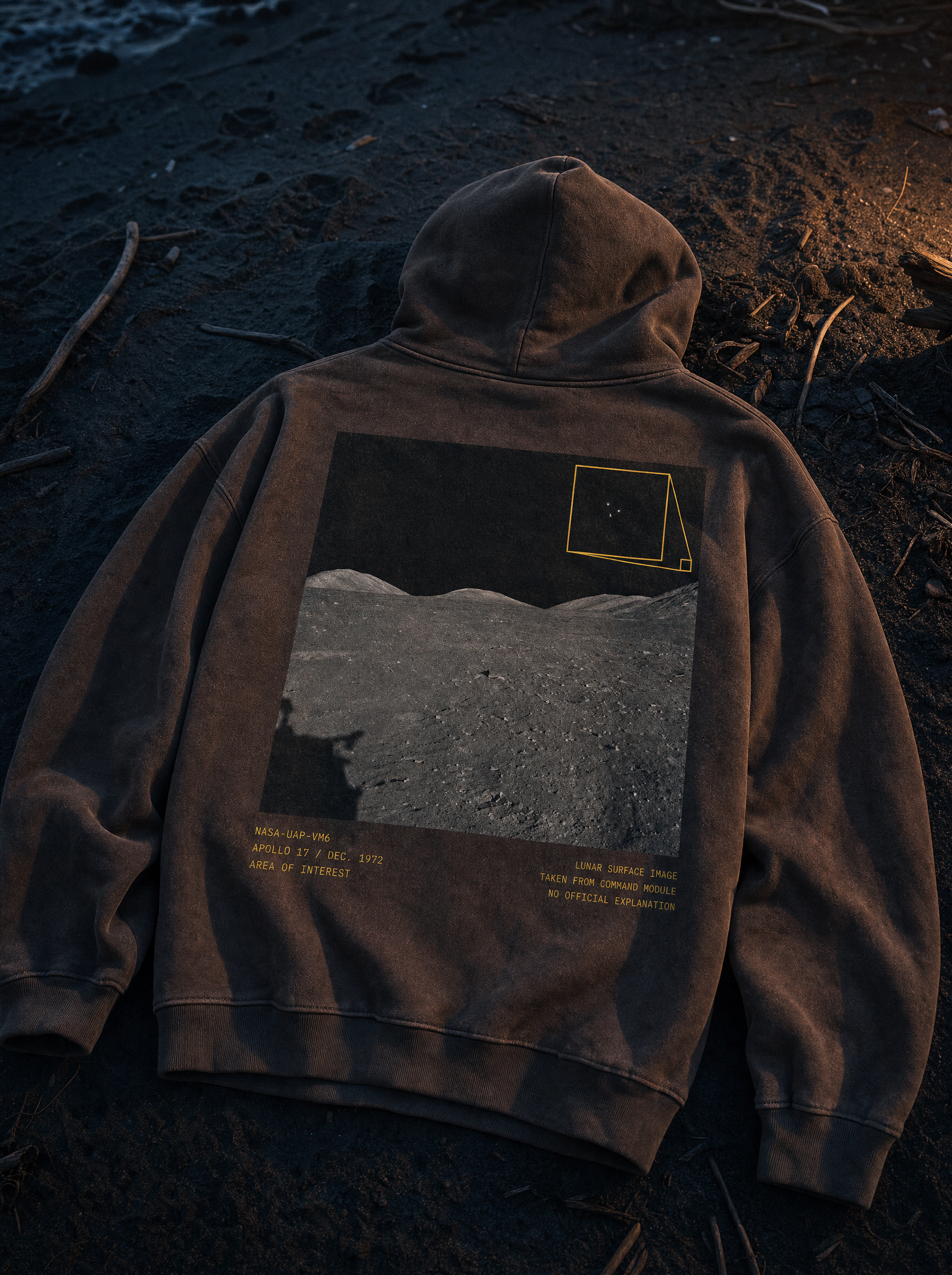 Apollo 17 Hoodie - flat lay on beach sand at twilight