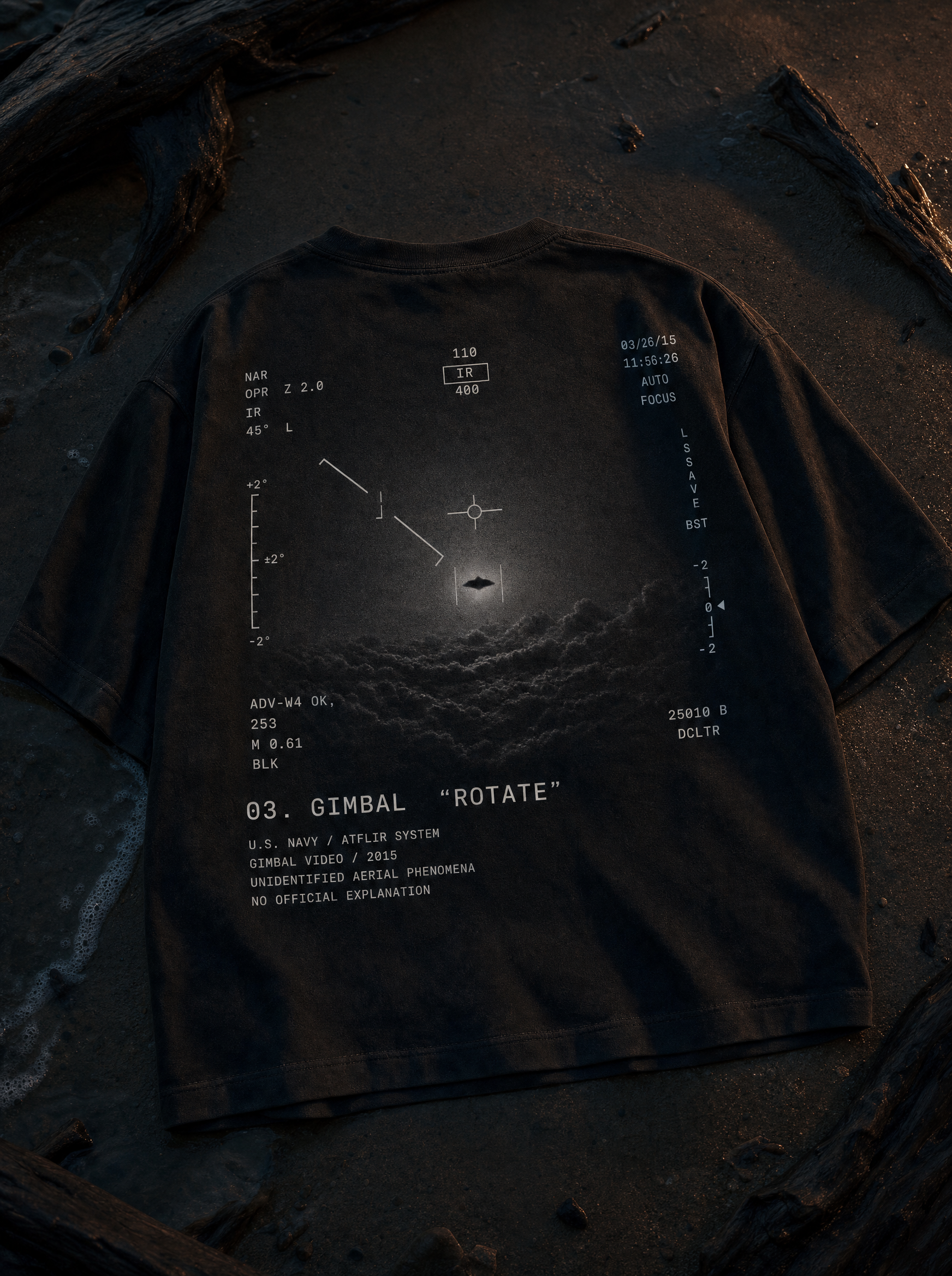Gimbal UAP Tee - flat lay on beach sand at twilight